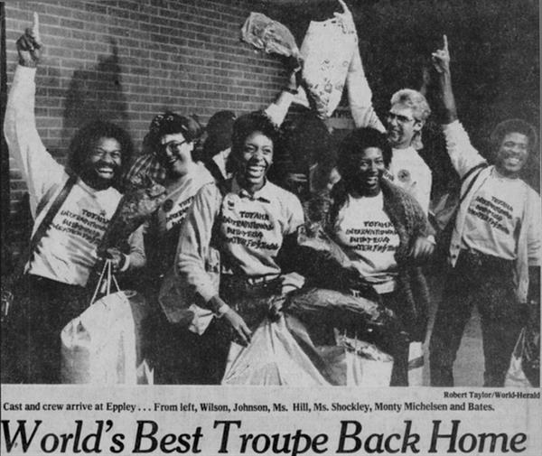 Newspaper Scan - a group of performers at an airport with headline World's Best Troupe Back Home